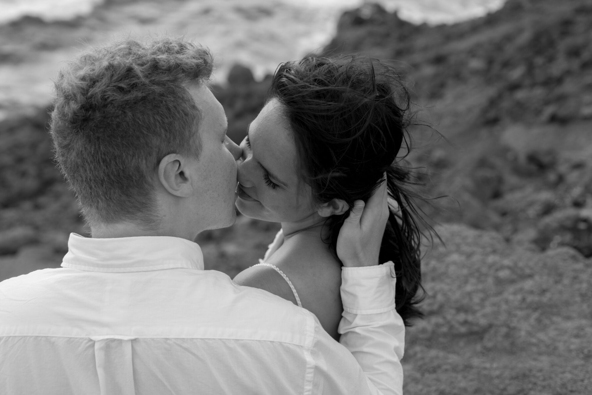 Jessie Hawaii Photography, Couple kissing passionately on a rocky beach
