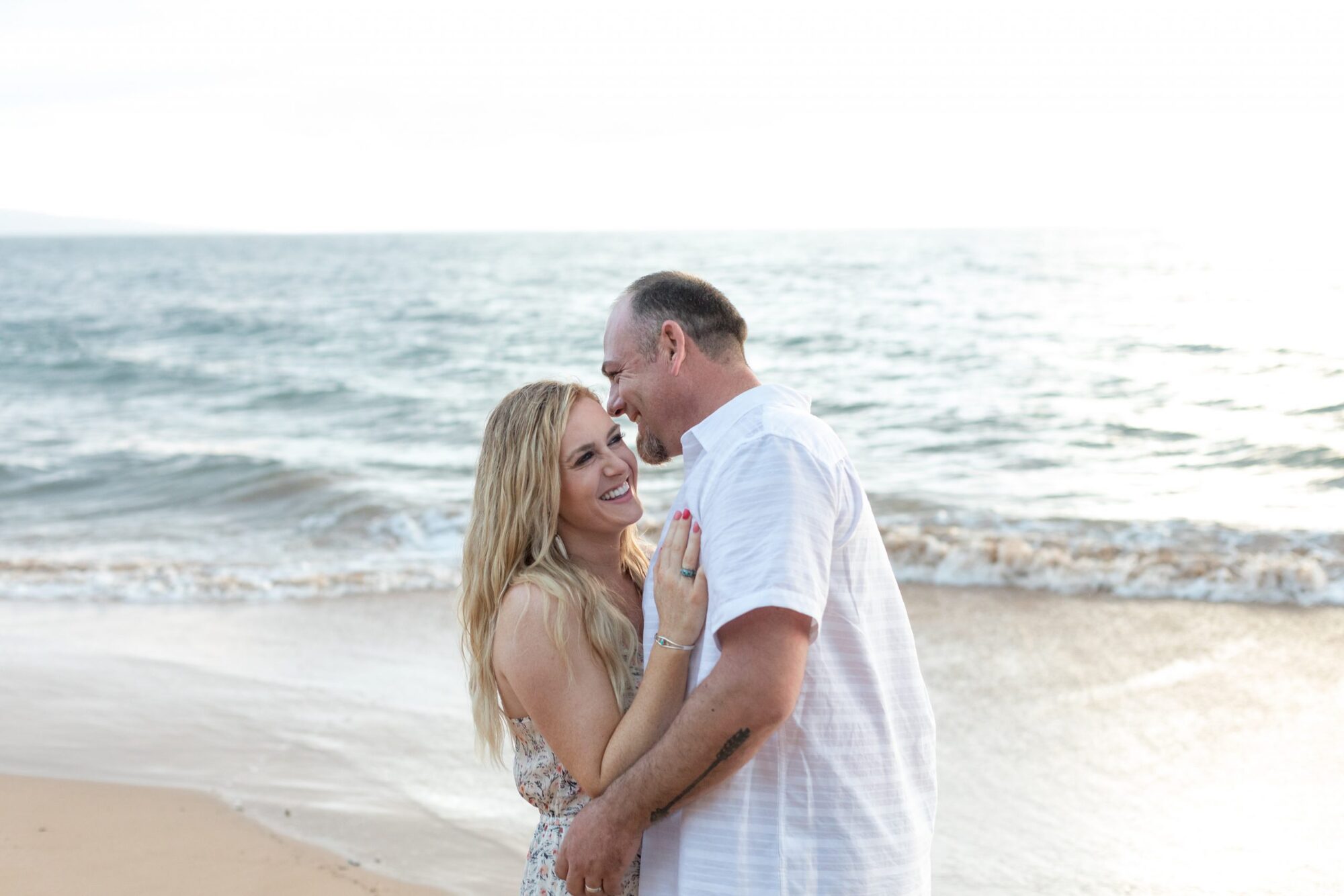 Jessie Hawaii Photography, Happy couple embracing on a beach at sunset