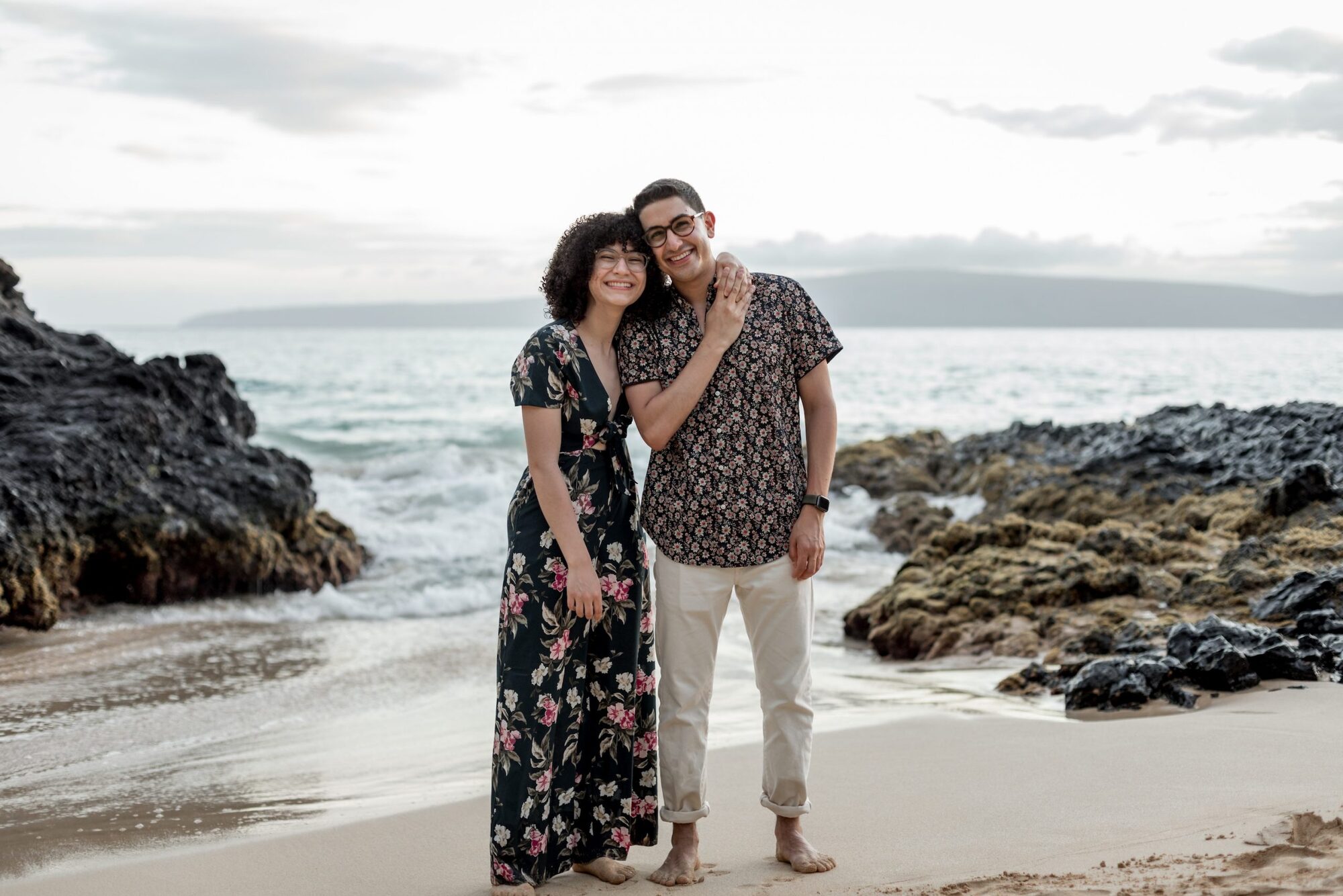 Jessie Hawaii Photography, Happy couple embraces on a beach at sunset.