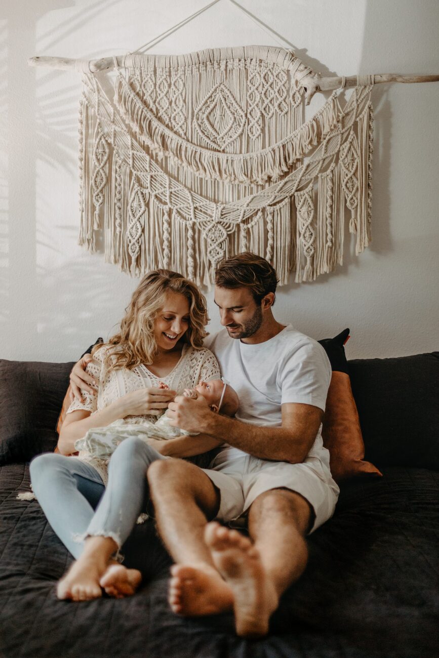 Jessie Hawaii Photography, Happy Maui family with newborn baby on bed