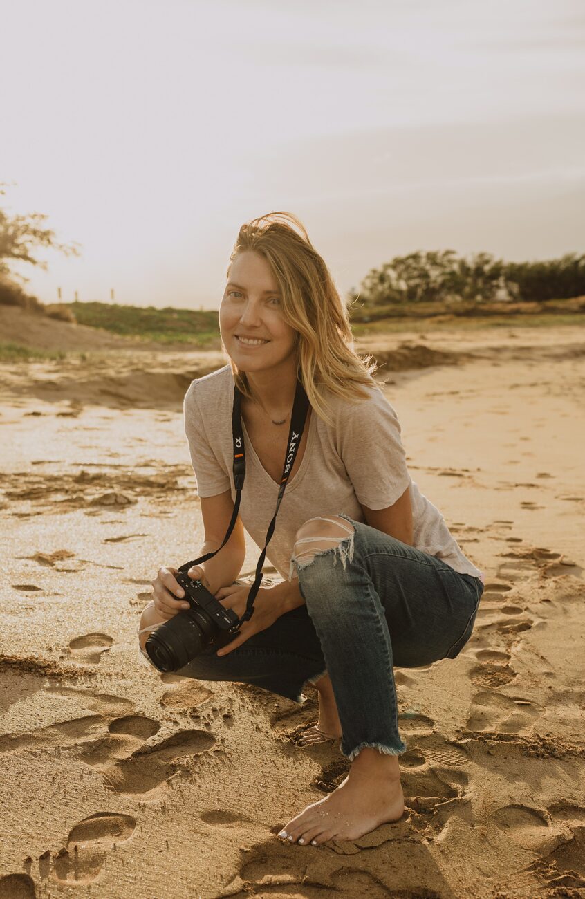 Jessie, Maui-based natural light photographer, smiling on the beach at golden hour